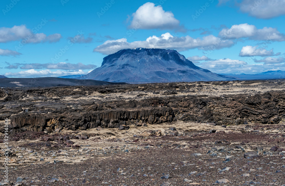 Herdubreid volcano mountain viewed from east and lava formations of Odadahraun desert are at foreground
