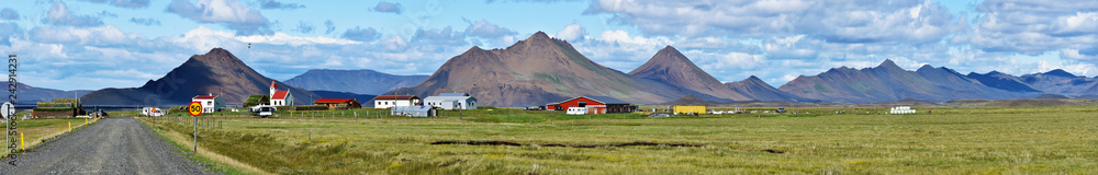 Panorama of Modrudalur farm, green grassland and Modrudalsjallgardar mountains at right