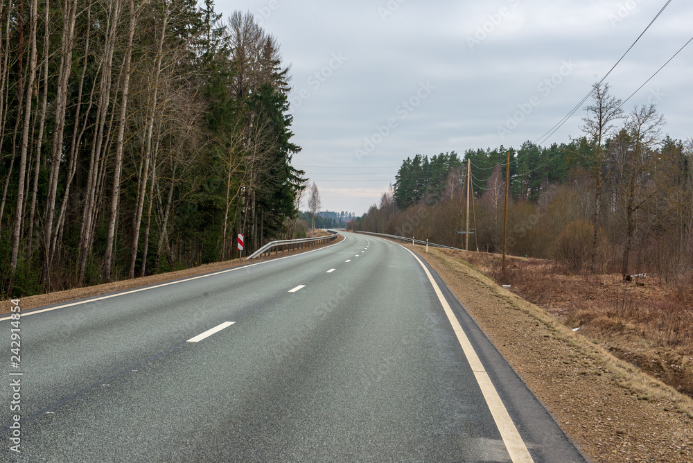 Fototapeta premium country gravel road with old and broken asphalt