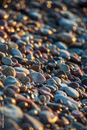 abstract details of rocky beach pebbles in sunset by the sea
