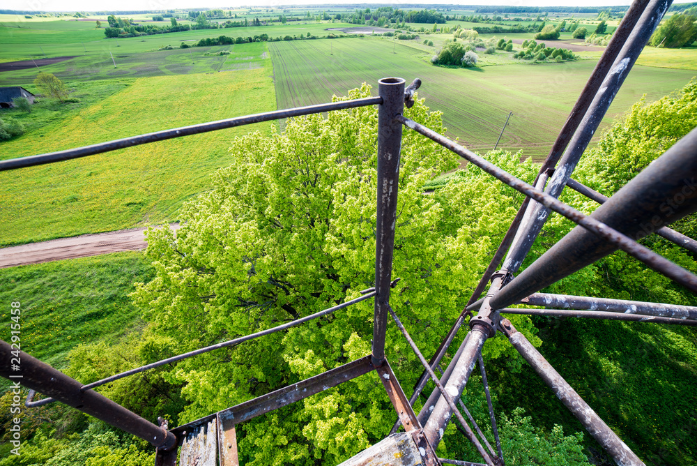Fototapeta premium watchtower details and wooden bars, stairs and walls from below up