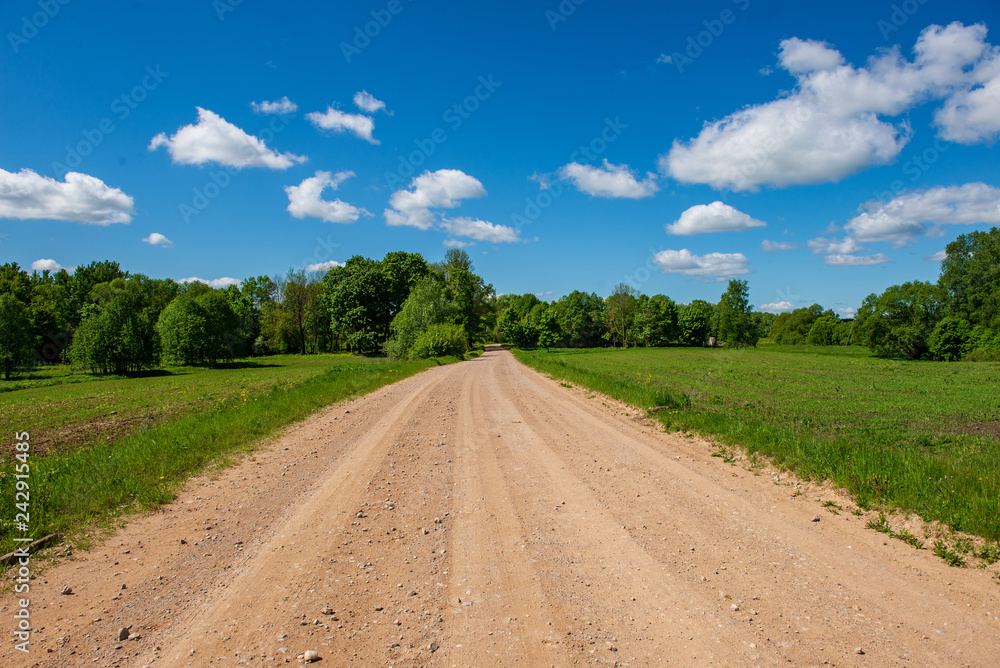 country gravel road with old and broken asphalt country gravel road with old and broken asphalt