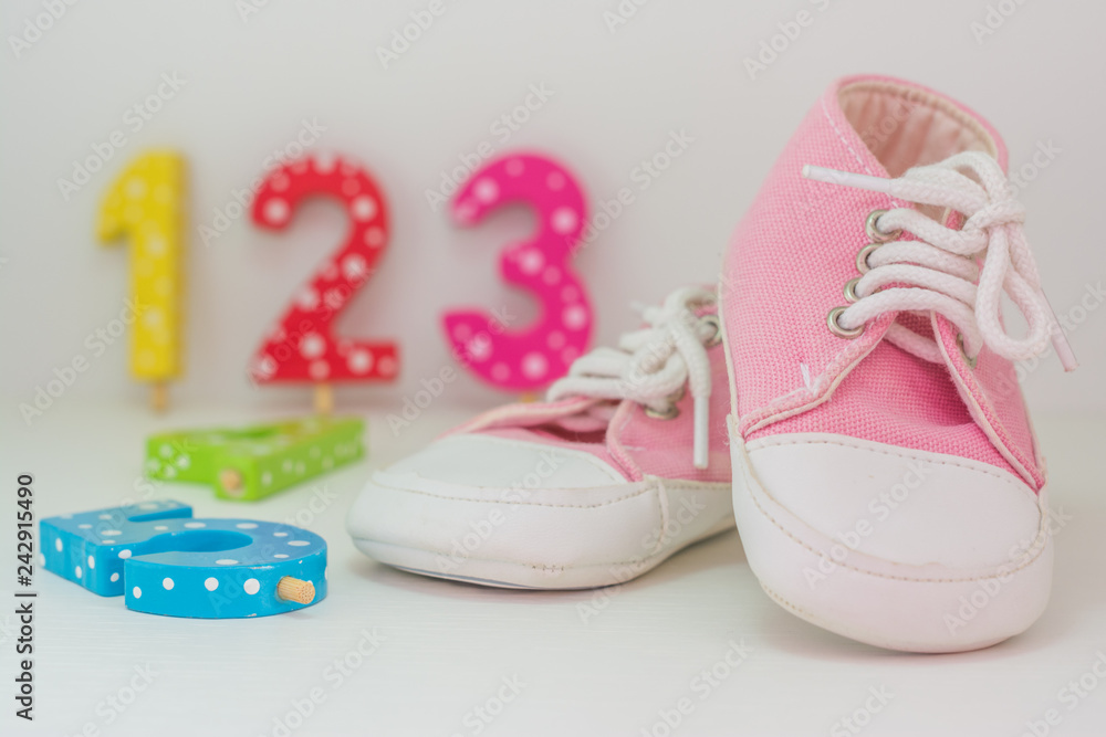 A pair of pink baby girl sneakers on white background