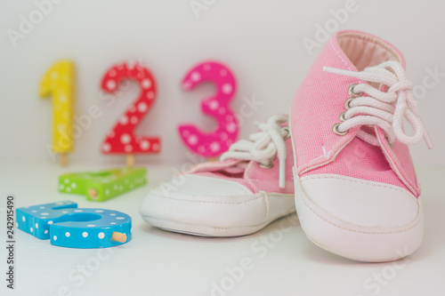 A pair of pink baby girl sneakers on white background