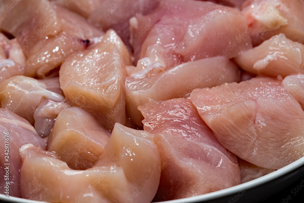 CUbed raw chicken for chicken, pepper and mushroom dish CUbed raw chicken for chicken, pepper and mushroom dish