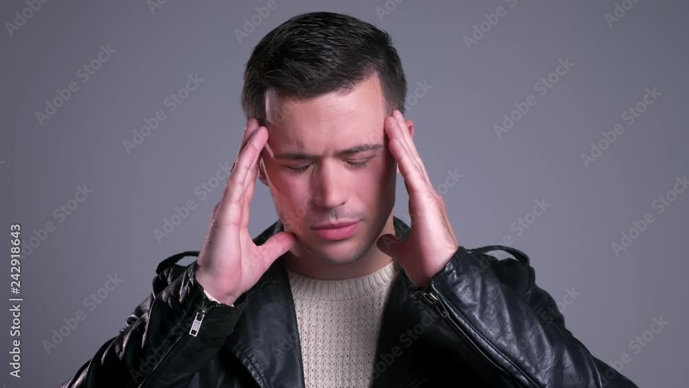 Closeup portrait of handsome caucasian man getting a headache and feeling ill Closeup portrait of handsome caucasian man getting a headache and feeling ill
