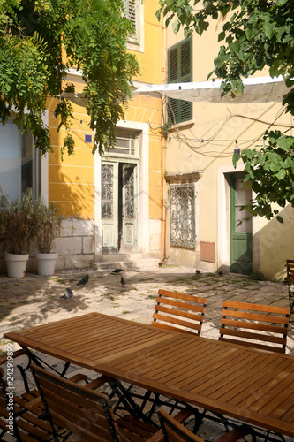 Charming cafe in a colorful narrow street in Sibenik, Croatia. Traditional Mediterranean architecture. Selective focus.