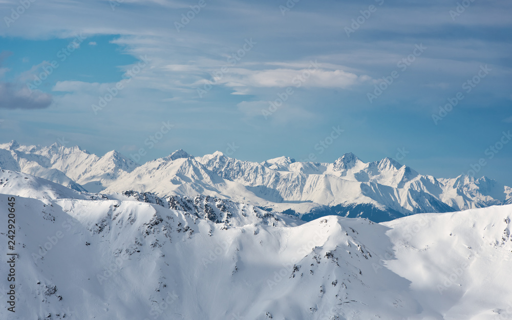 Hochfuegen, Zillertal, Tirol / Austria - January 08, 2018: a view of the beautiful Alpine peaks covered in snow, in the direction of Zugspitze, winter landscape Hochfuegen, Zillertal, Tirol / Austria - January 08, 2018: a view of the beautiful Alpine peaks covered in snow, in the direction of Zugspitze, winter landscape
