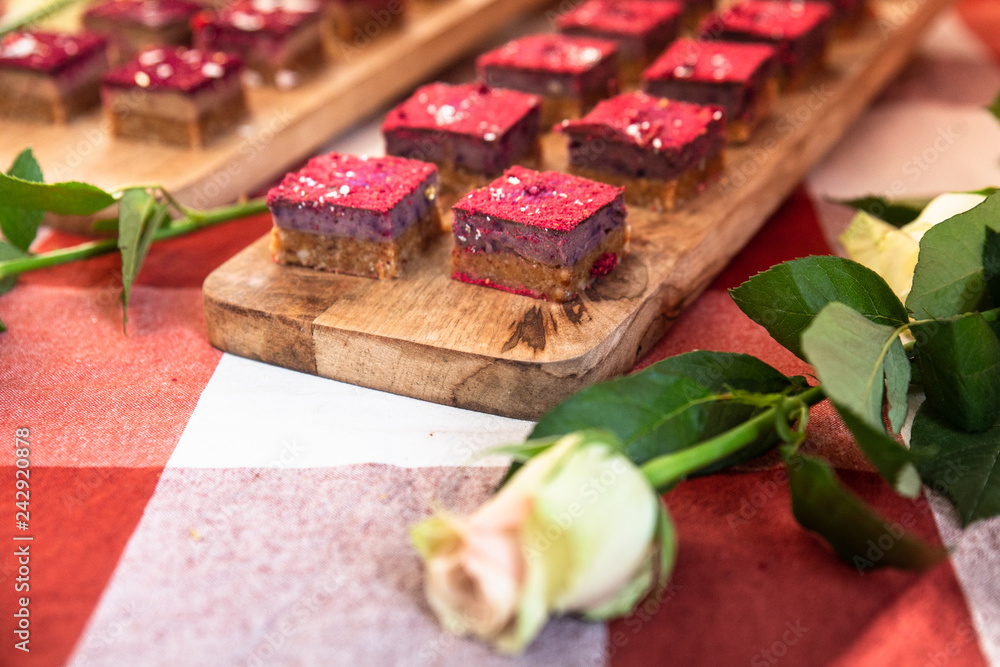 Display of beautiful sweet miniature cakes with a white rose Display of beautiful sweet miniature cakes with a white rose