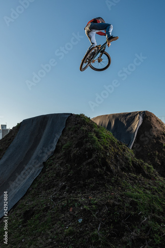 MTB Bike jump over a dirt trail