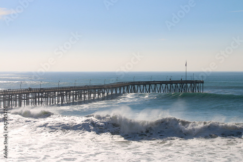 Ventura California Pier during super tide in winter on bright day