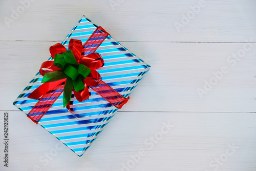 Christmas and Happy new year composition, Christmas present gift boxes with red ribbon on wooden white background. Flat lay, top view, copy space.