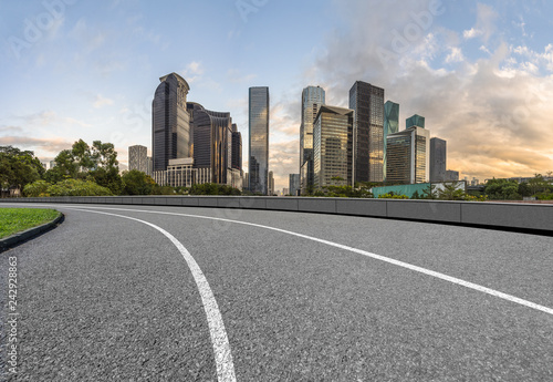 curve asphalt road with city skyline background in china