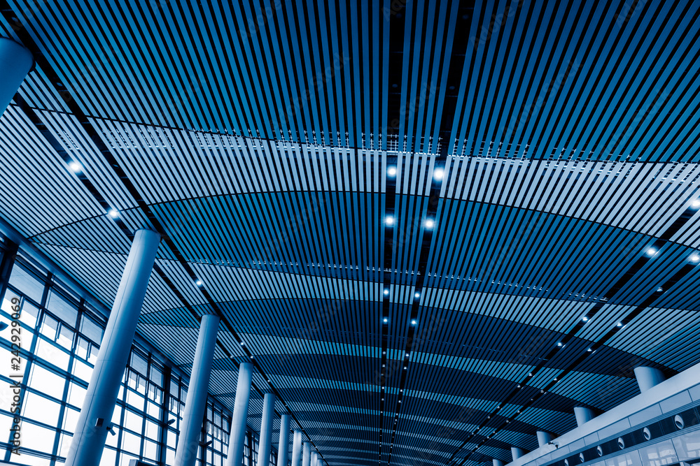 Naklejka premium low angle view of steel glass airport ceiling, shenzhen china,blue toned image.