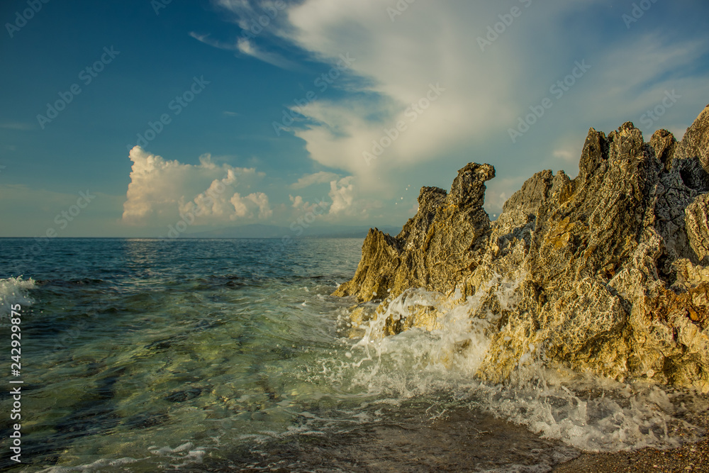 Idyllic ocean rocky sand waterfront shoreline wallpaper post card landscape concept