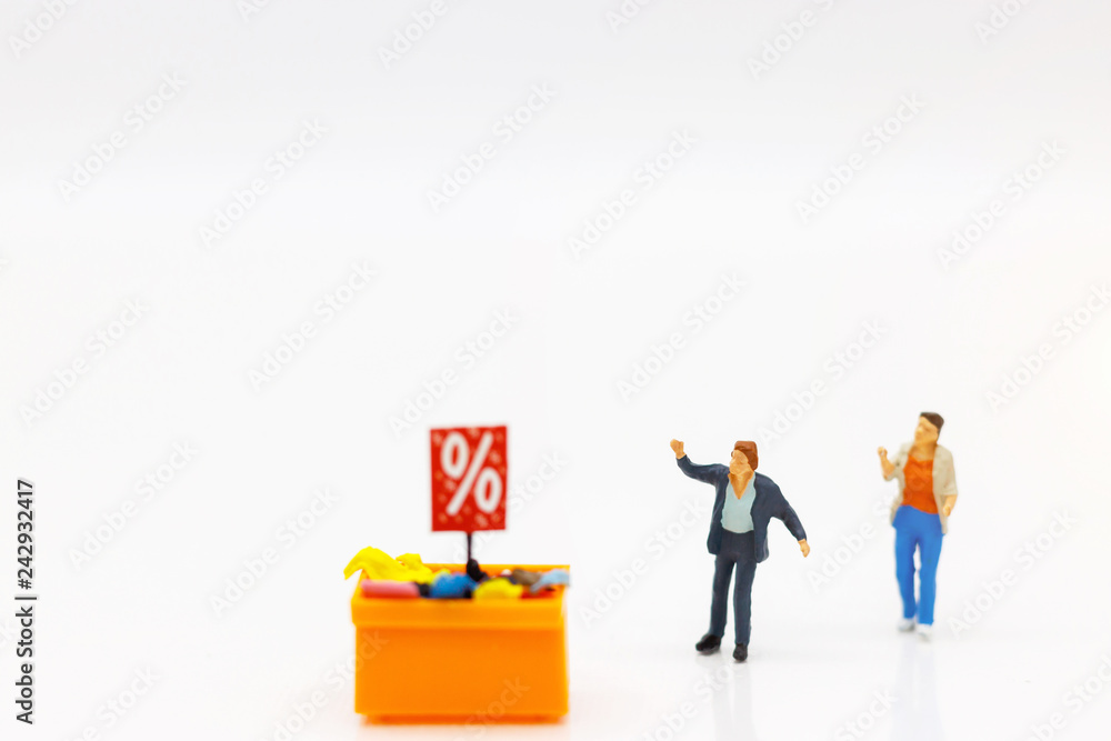 Miniatrue people: Shoppers buy goods on sale with discount tray. Tourism, shopping or business concept. Miniatrue people: Shoppers buy goods on sale with discount tray. Tourism, shopping or business concept.