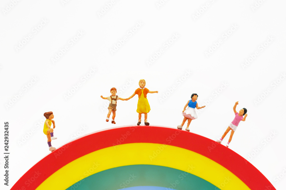 Miniature people: family and children enjoy on rainbow, happy family day concept. Miniature people: family and children enjoy on rainbow, happy family day concept.