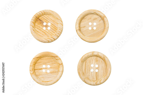 Large wooden sewing buttons with four holes on isolated background 