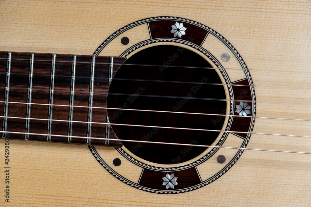 Closeup of rosette sound hole of an acoustic guitar Closeup of rosette sound hole of an acoustic guitar