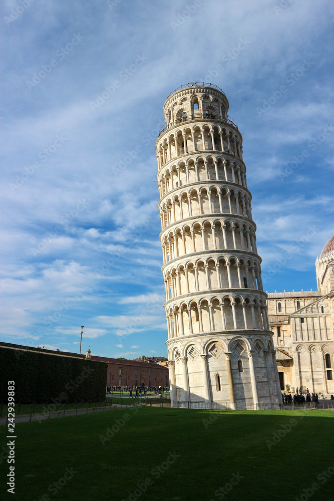 Leaning tower of Pisa at the winter sunny day with the blue sky on the background, Tuscany, Italy