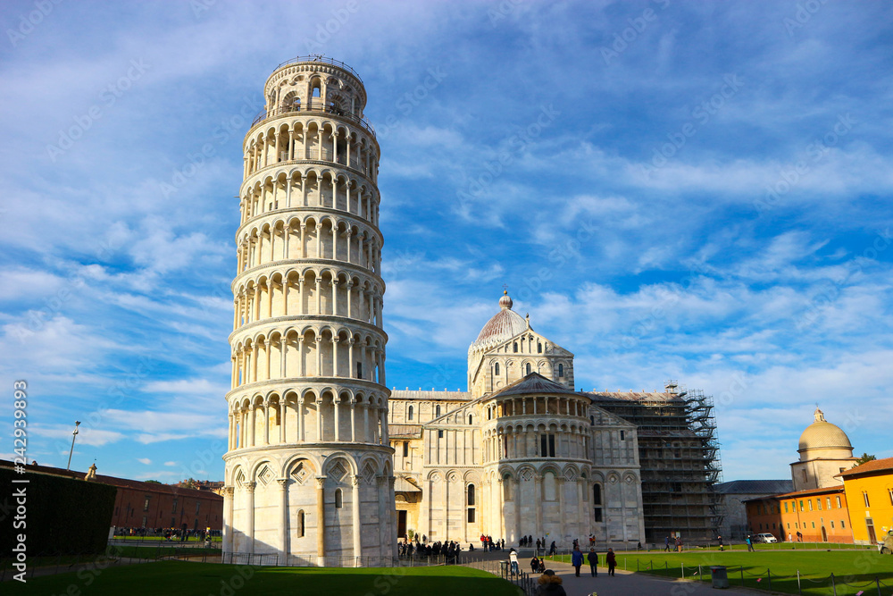 Pisa cathedral and leaning tower with a blue sky on the background at winter sunny day, Tuscany, Italy