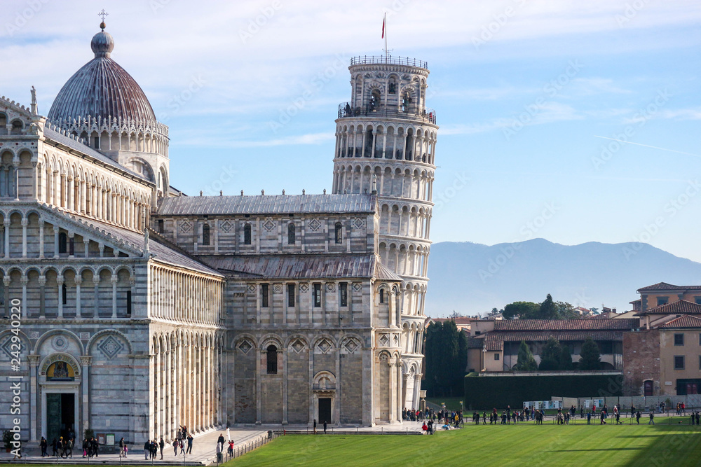 Leaning tower of Pisa, symbol of Italy, and Pisa cathedral, with Tuscany mountains on the background