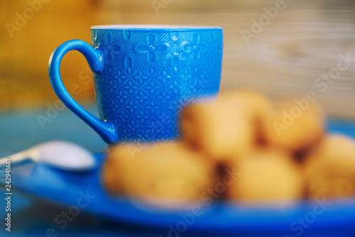 Coffee mug on a wooden turquoise background.