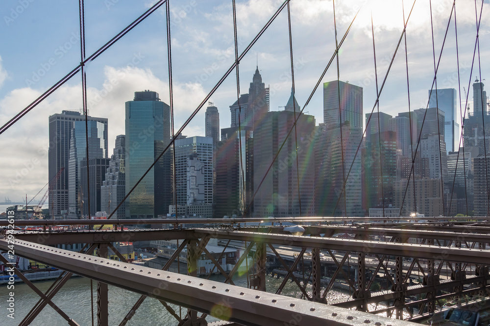 View from the Brooklyn Bridge on the lowstanding Sun over Manhattan, New York, United States
