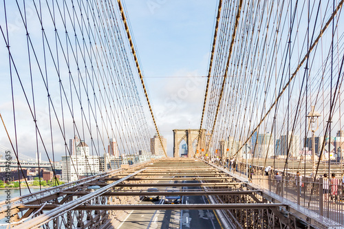 Views of the city part Brooklyn between the steel cables of the Brooklyn Bridge, New York, United States © Emma