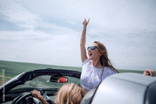 close up. happy young woman traveling in a convertible © ASDF