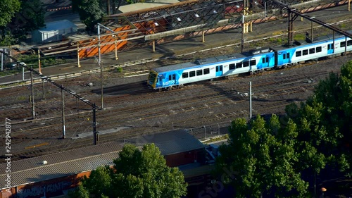 Trains leaving station on railway tracks from Melbourne photo