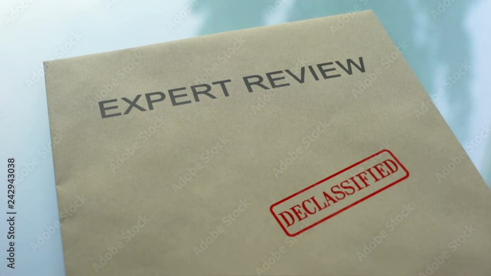 Expert review declassified, stamping seal on folder with important documents