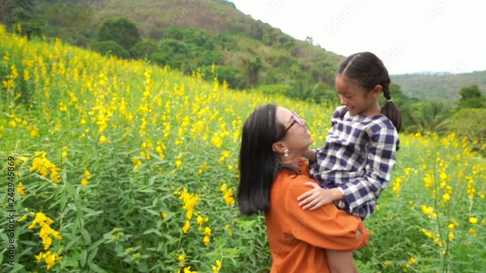 Mom hold and hug daughter in the field, love concept Mom hold and hug daughter in the field, love concept