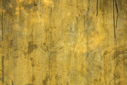 old dirty yellow wall with scratches and black spots. rough surface texture