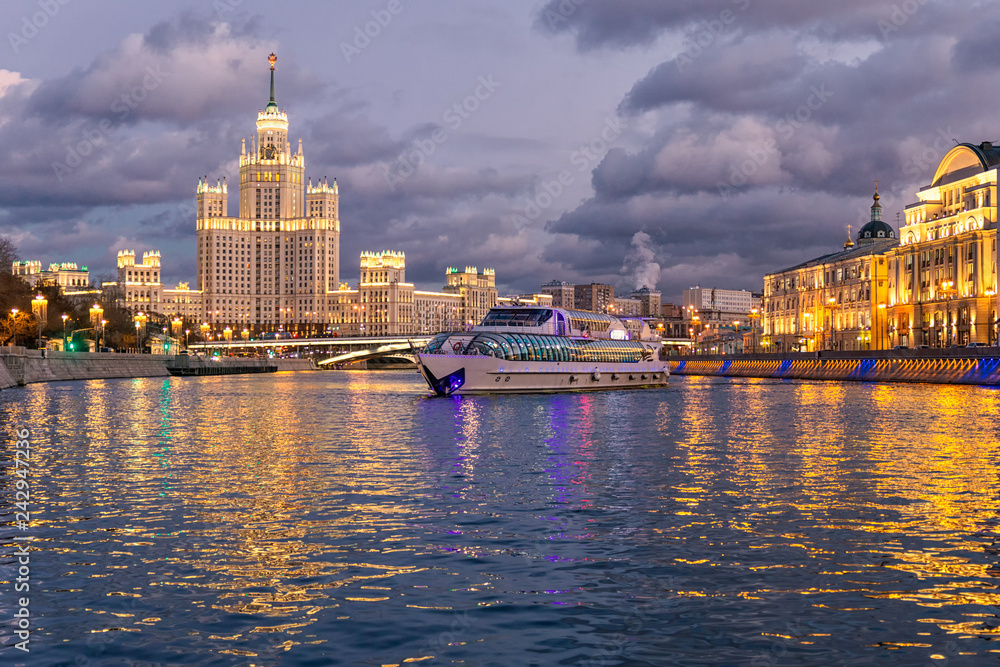 Moskva river night view and a touristic boat cruising