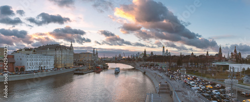 Panorama of beautiful sunset over Moskva river, traffic jam near Kremlin and a touristic boat cruising