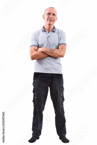 Full body shot of happy senior man smiling while wearing eyeglas photo