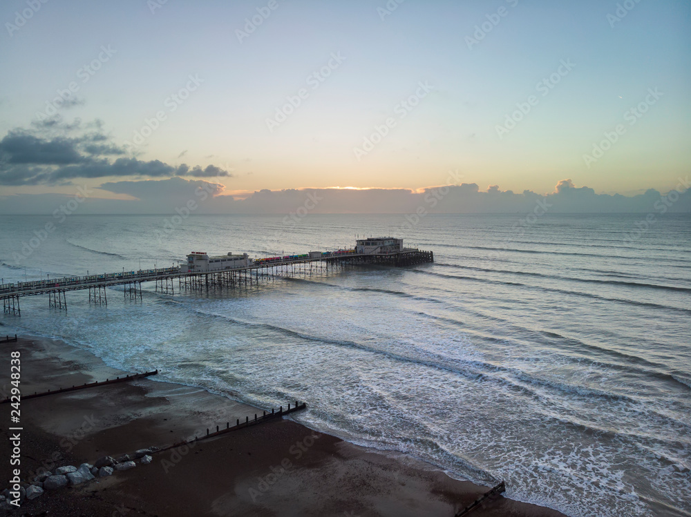 Drone aerial view landscape image of Worthing pier on Sussex coast in England at dawn