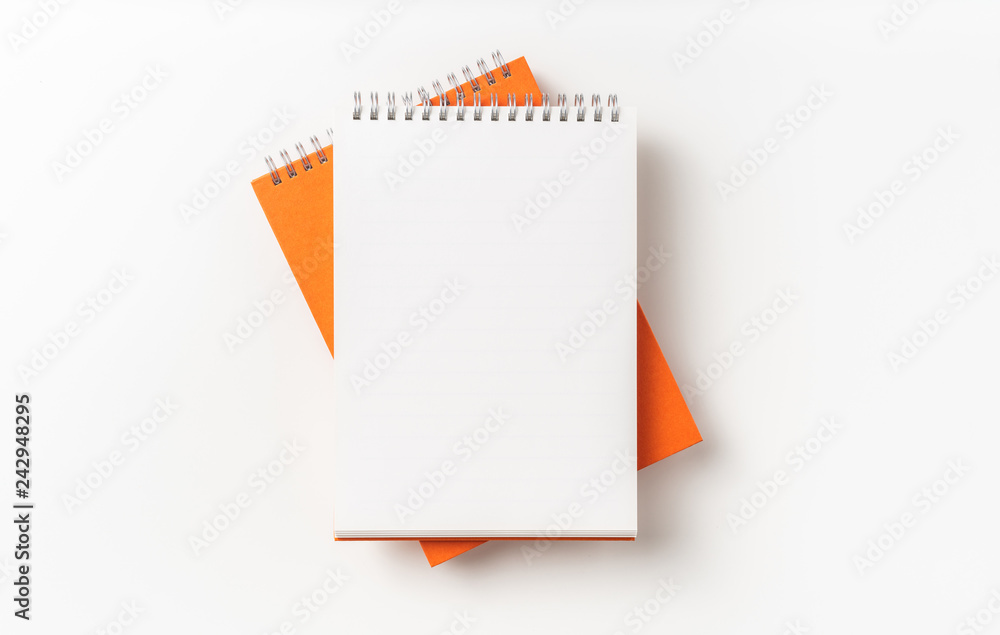 Top view of orange spiral notebook, page, pencil Top view of orange spiral notebook, page, pencil
