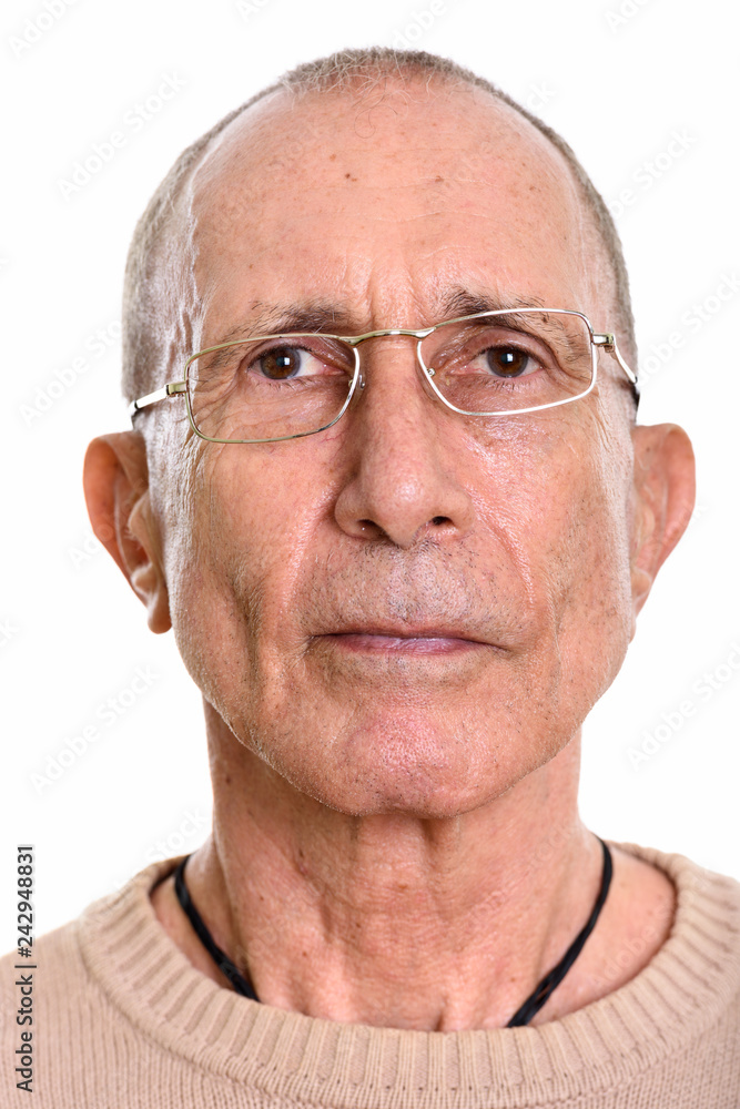 Face of senior man wearing eyeglasses isolated against white background Face of senior man wearing eyeglasses isolated against white background