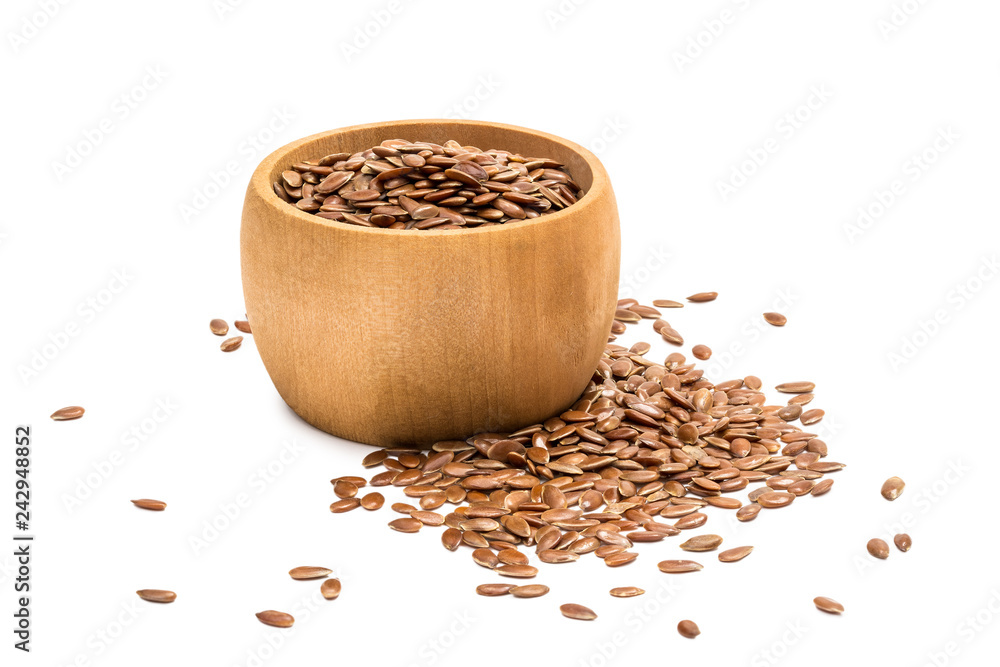 Small wooden bowl with linseeds or flax seeds seen from the side with some spilled in front and right and isolated on white background Small wooden bowl with linseeds or flax seeds seen from the side with some spilled in front and right and isolated on white background