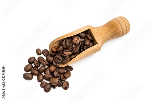Small wooden spoon or scoop with coffee beans seen from above and isolated on white background