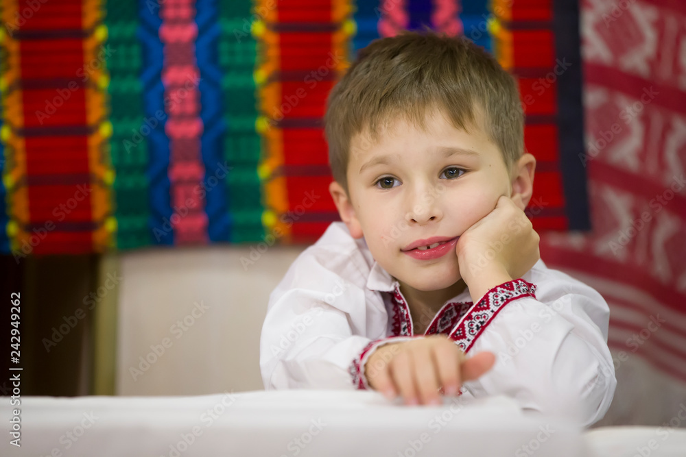 Portrait of a small Belarusian or Ukrainian boy in embroidery.The boy in Slavic clothes Portrait of a small Belarusian or Ukrainian boy in embroidery.The boy in Slavic clothes