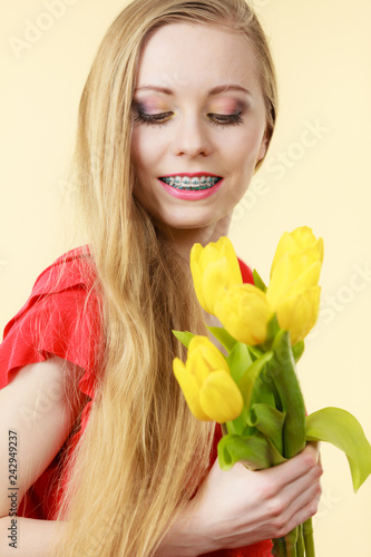 Pretty woman with yellow tulips bunch