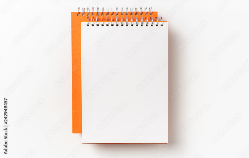 Top view of orange spiral notebook, page, pencil Top view of orange spiral notebook, page, pencil