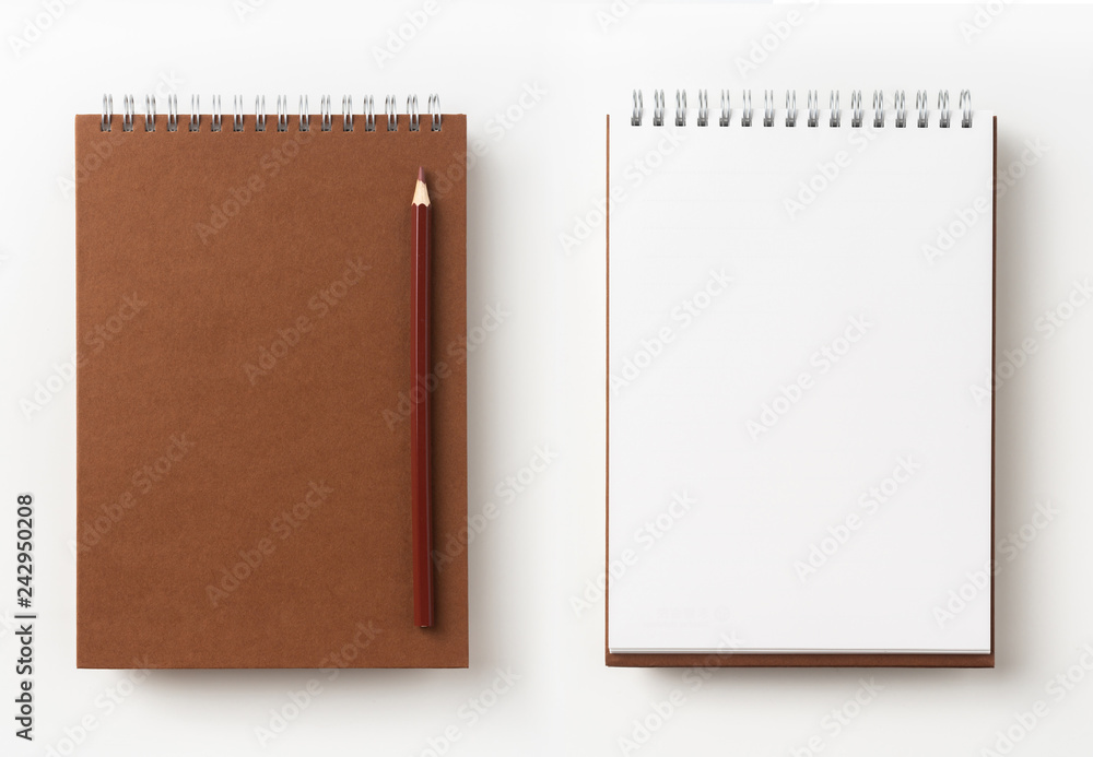 Top view of brown spiral notebook, page, pencil Top view of brown spiral notebook, page, pencil