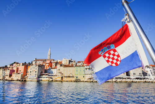 Flag of Croatia with Rovinj town at background, Istria, Croatia. Travel tourism concept. Croatian vacations photo