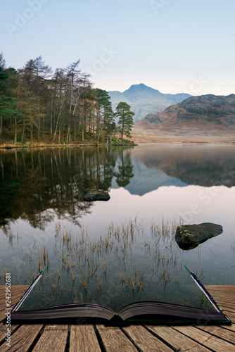 Beautiful Autumn Fall colorful sunrise over Blea Tarn in the Lake District with High Raise and The Langdales in the distance coming out of pages of open story book