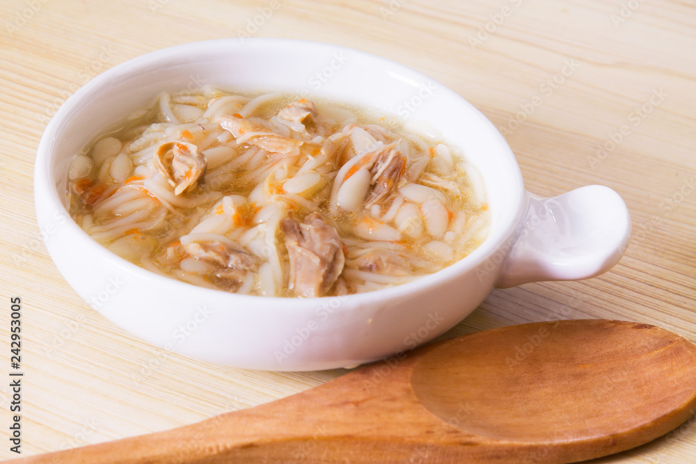 Homemade simple soup in white mug Homemade simple soup in white mug