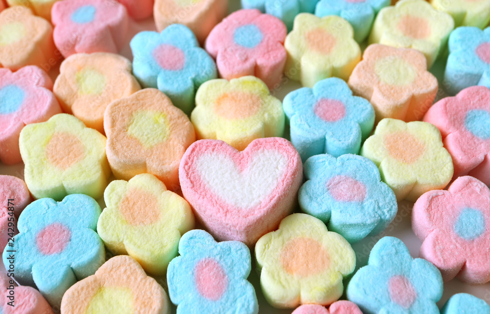 Only One Pink and White Heart Shaped Among Heap of Pastel Color Flower Shaped Marshmallow Candies Only One Pink and White Heart Shaped Among Heap of Pastel Color Flower Shaped Marshmallow Candies